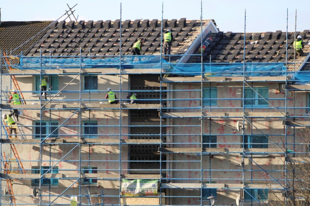 Roofers using scaffolding to work at height